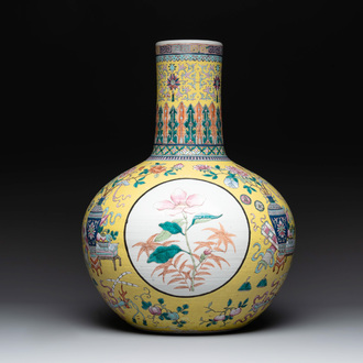 A large Chinese famille rose yellow-ground 'tianqiu ping' vase with flowers and antiquities, 19th C.
