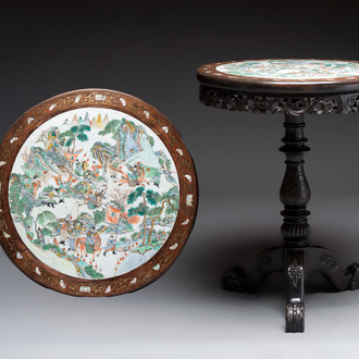 A Chinese mother-of-pearl-inlaid hongmu table with a circular Canton famille verte 'warriors on horseback' plaque, 19th C.