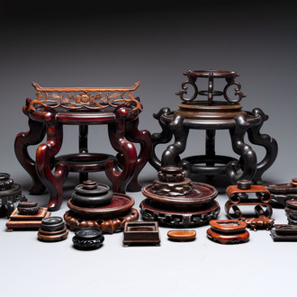 A collection of 30 Chinese wooden stands, 19/20th C.