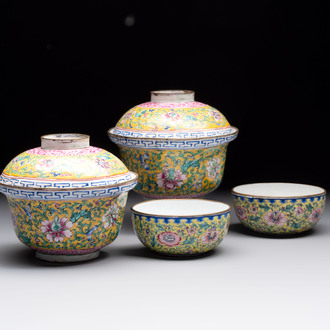 A pair of Chinese yellow-ground Canton enamel covered bowls and two cups, Yongzheng/Qianlong