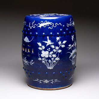 A Chinese white-slip-decorated blue-ground garden seat with floral design, 19th C.