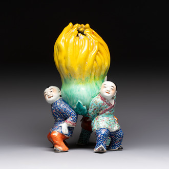 A Chinese famille rose figure of three boys holding a Buddha’s hand, Republic