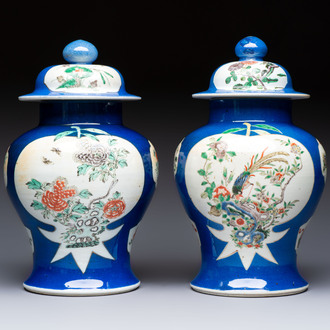 Two Chinese famille verte blue-ground vases and covers, 19th C.