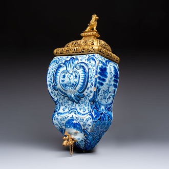 A large blue and white Dutch Delft 'Fountain of Youth' wall cistern with impressive reticulated gilt bronze cover, 18th C.