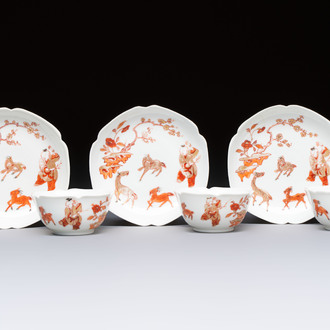 Three fine Chinese eggshell iron-red and gilt-decorated 'Boy and Goats' cups and saucers, Yongzheng
