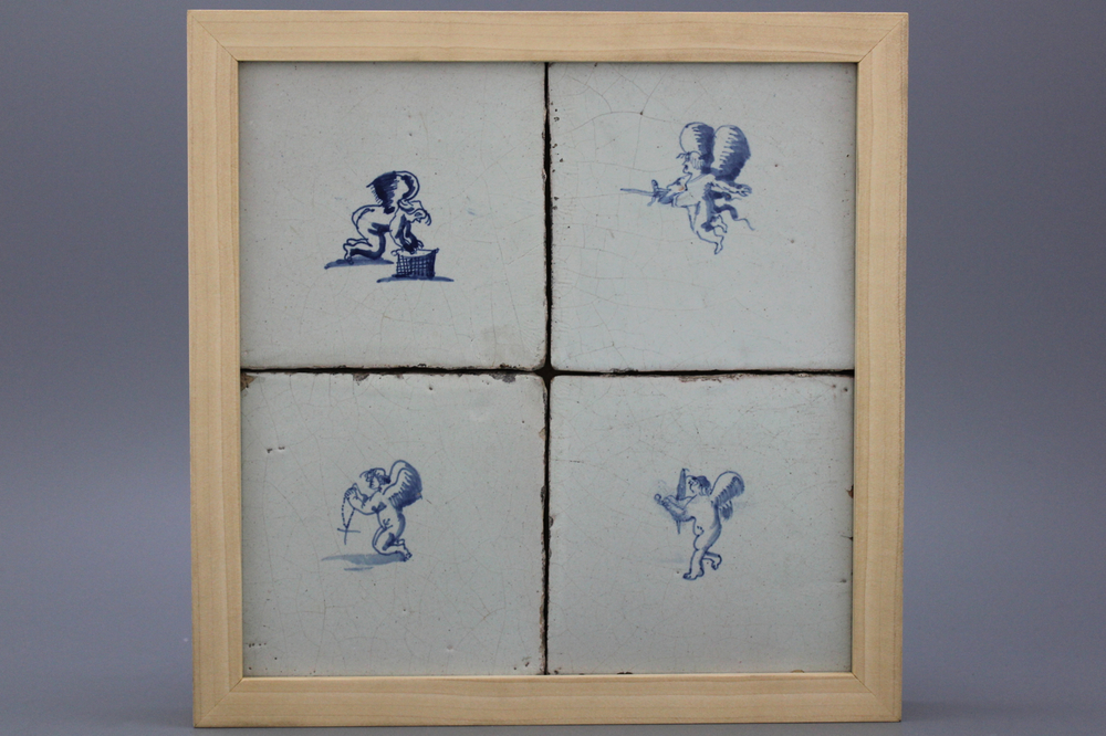 A framed set of 4 Dutch Delft tiles with amors 17th C.