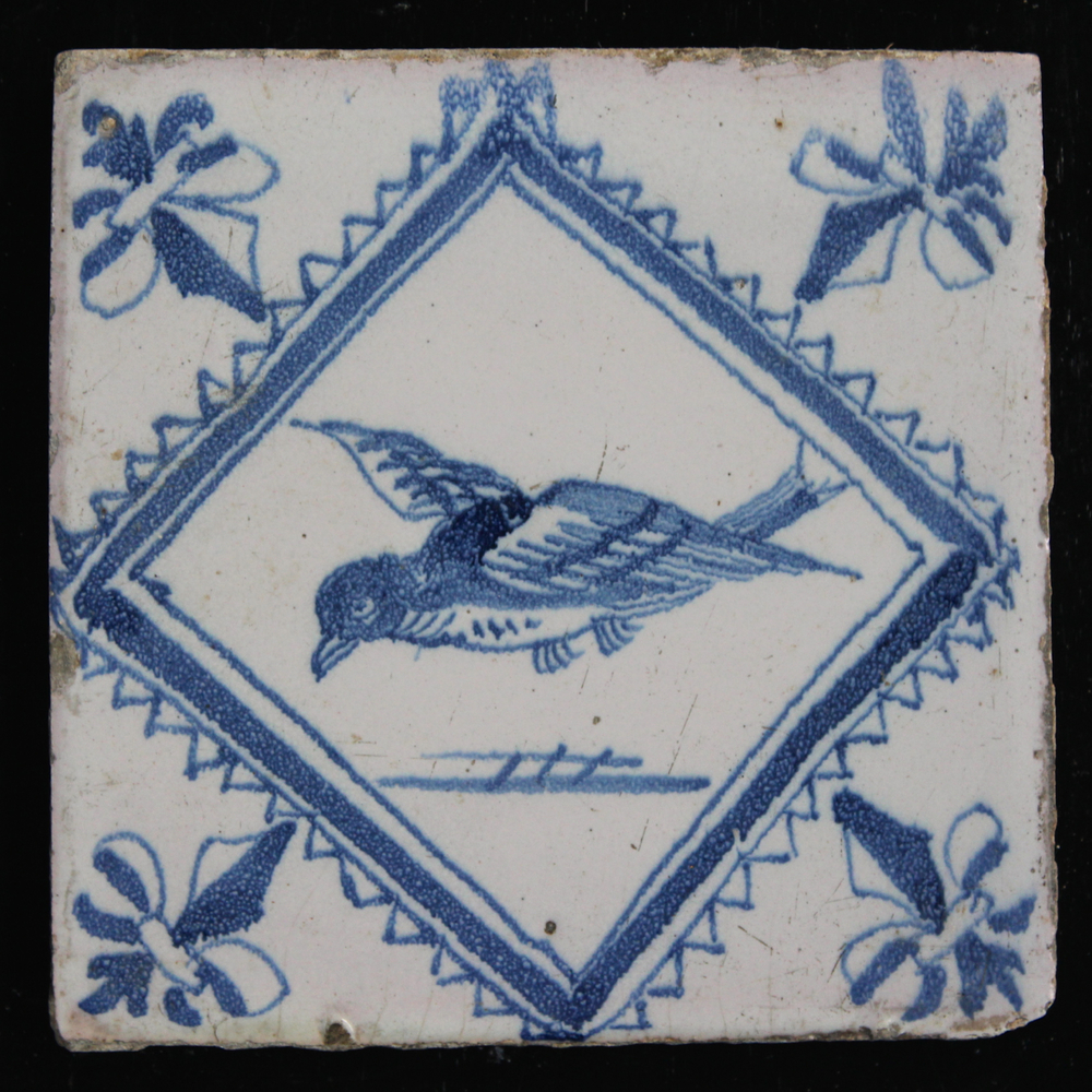 A set of 14 matching Dutch Delft blue and white tiles with birds in a lozenge frame, 18th C.