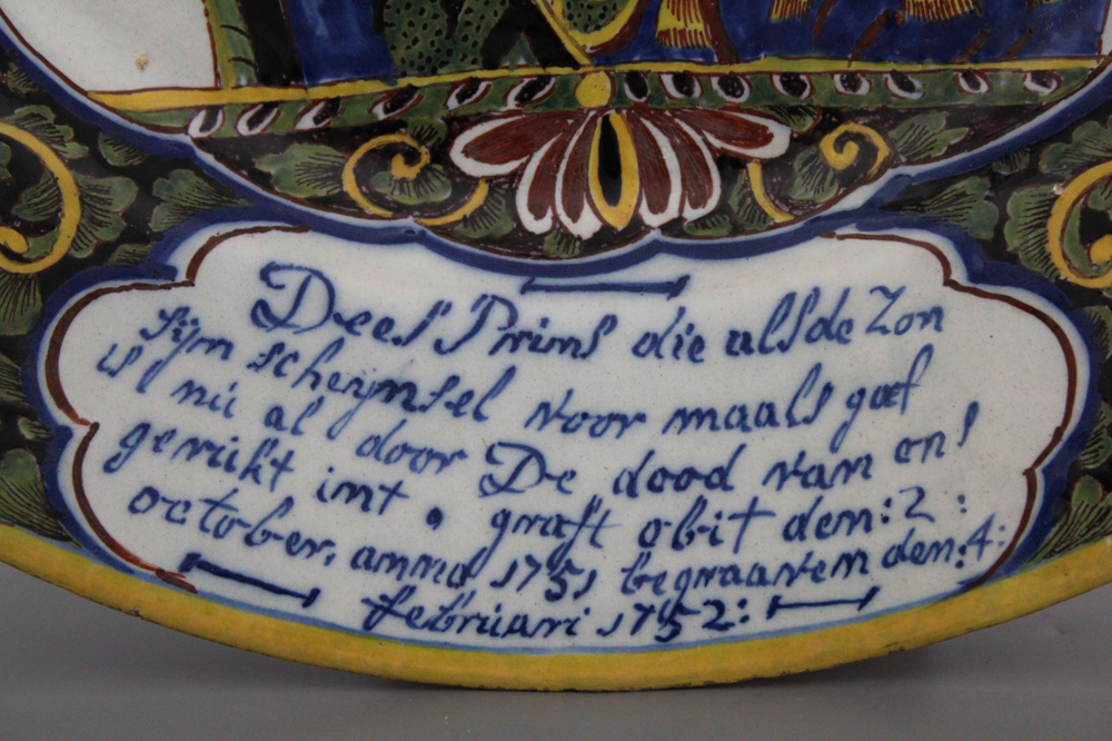 An important commemorative royalist Dutch Delft portrait dish with mixed technique border, reinforced with black and dated ca. 1752