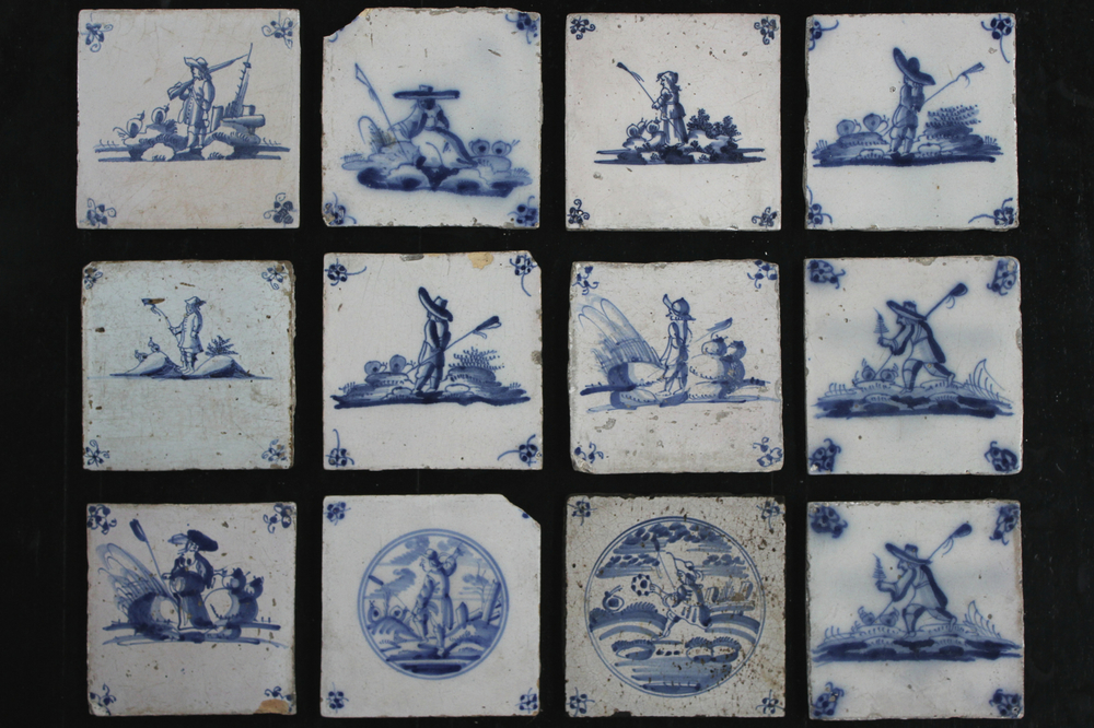 A set of 27 Dutch Delft blue and white tiles with various scenes, 18th/19th C.