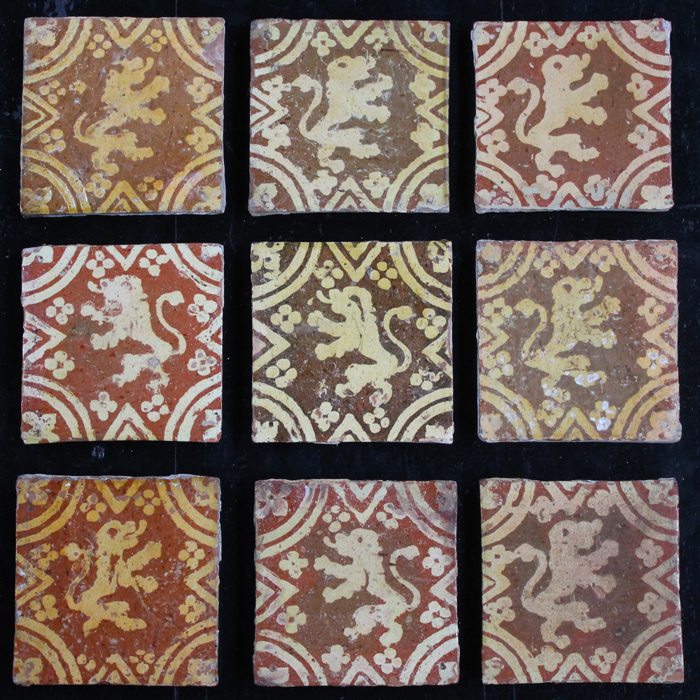 A lot of 9 slipware decorated post-medieval tiles with rampant lions, 17/18th C., Franco-Flemish