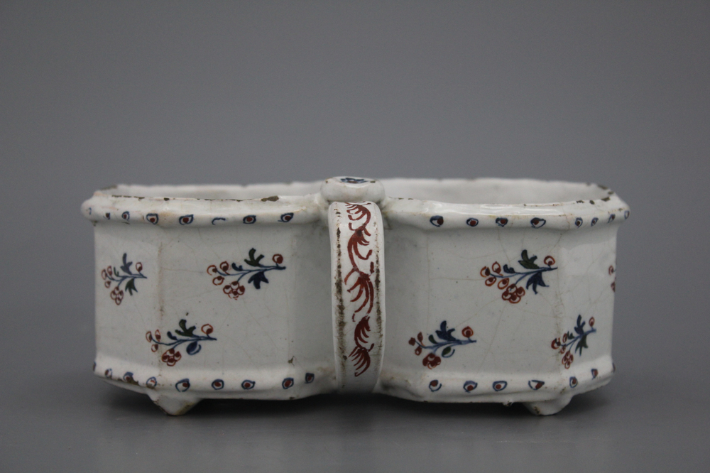 A Brussels faience &quot;floral hedge&quot; cruet stand, 18th C.