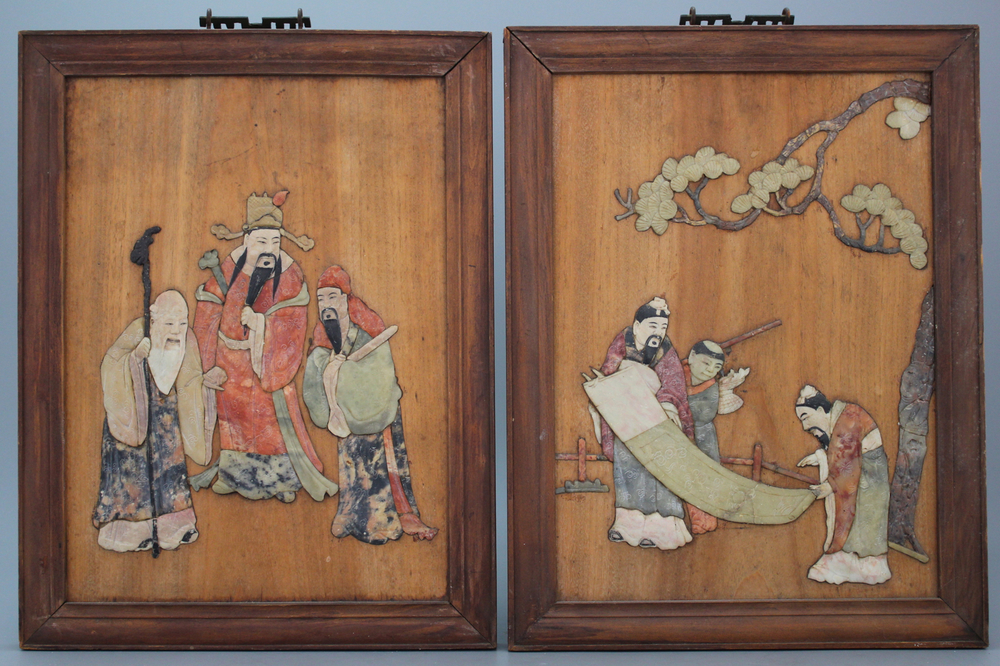 A pair of Chinese wooden panels with soap stone decoration, ca. 1900
