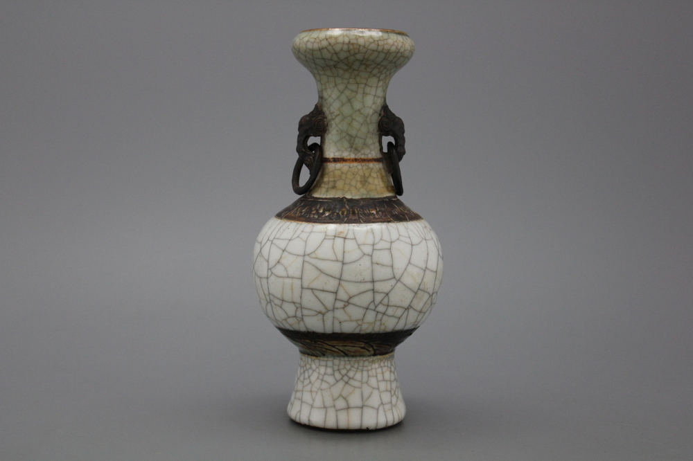 A Chinese crackle glazed bottle vase with elephant handles, 19th C.