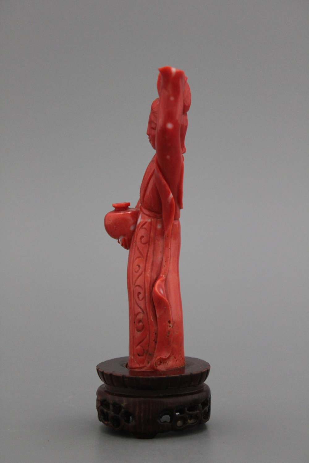 A carved Chinese red coral figure of a Guanyin, 19th C.