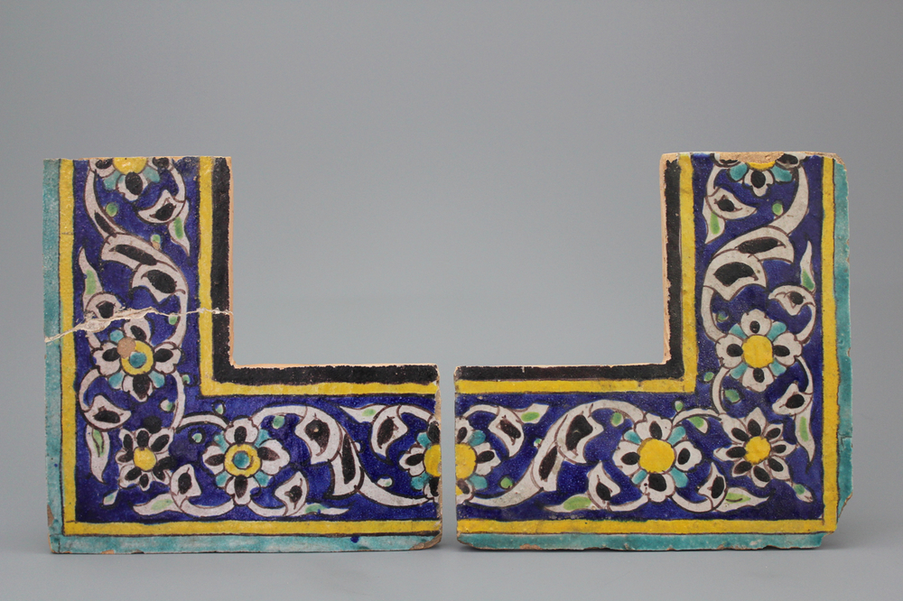 A pair of Isfahan cuerda seca corner tiles, 18/19th C.