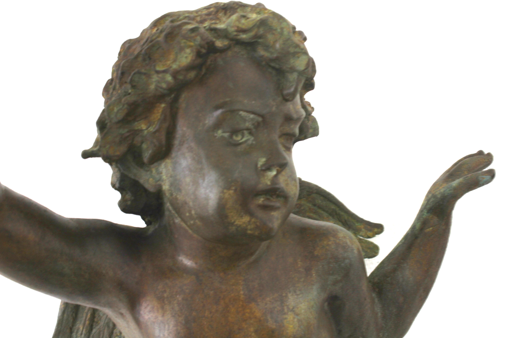 A large cast bronze figure of putto holding a cornucopia, ca. 1900