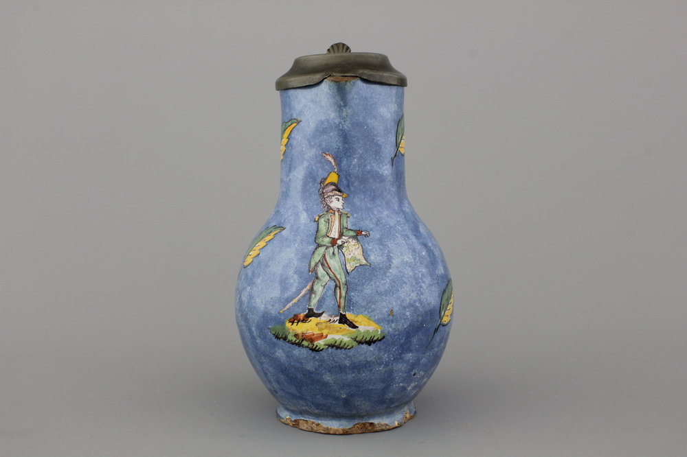 A rare Brussels faience blue ground jug with a soldier, 18th C.