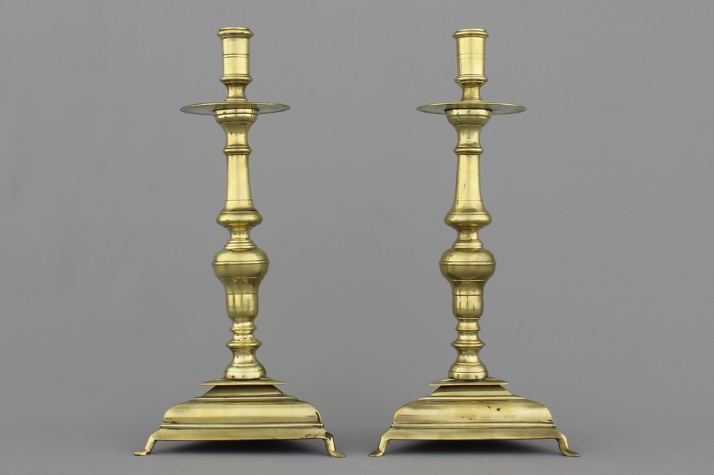 A pair of Spanish bronze candlesticks on triangular bases, 17th C.