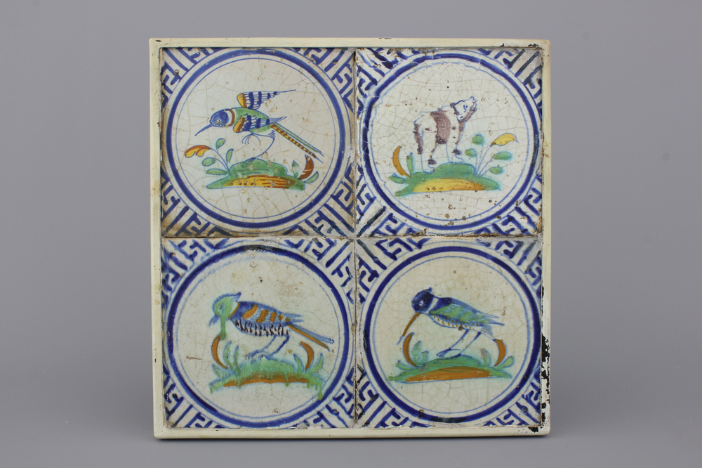 A framed set of 4 polychrome Dutch Delft tiles with a bear and birds, 17th C.