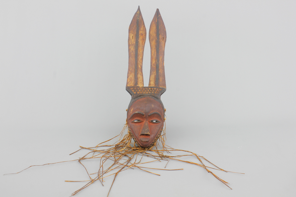 An African carved wood mask with raffia, East-Pende, early to mid 20th C.
