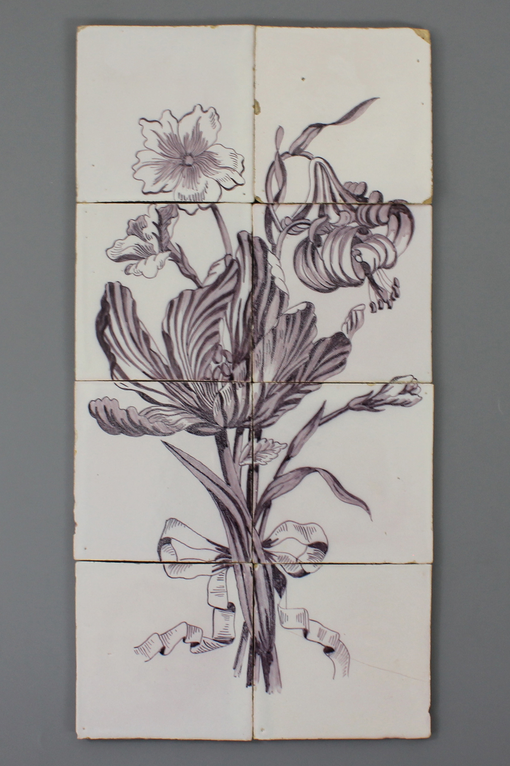A Dutch Delft manganese tile panel of a bouquet, 19/20th C.