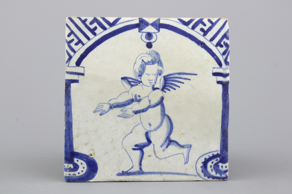 Carreau en fa&iuml;ence de Delft, bleu et blanc, d&eacute;cor d'un putto dress&eacute;, 17e