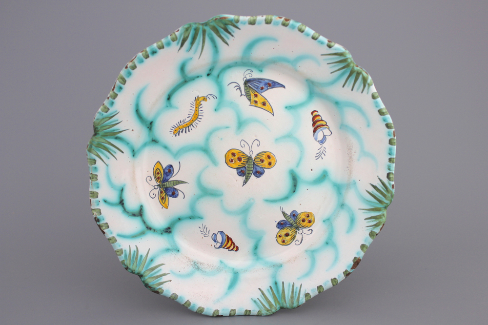 A Brussels faience scalloped butterfly decor plate, 18th C.
