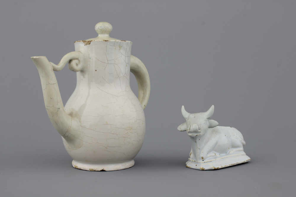 A white Delft model of a recumbent cow and a lidded jug, both 18th C.