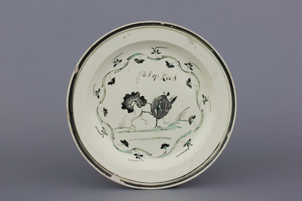 A Dutch-decorated English Leeds orangist creamware plate with a dog and inscription, 18th C.