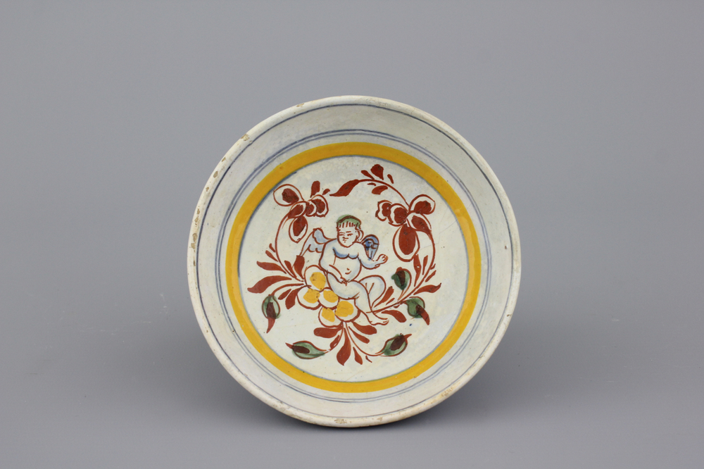 A Dutch Delft polychrome bowl with a putto, 17th C.
