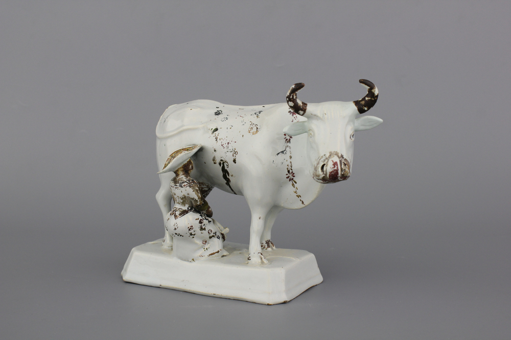 A white Delft cold-painted cow and milker group, 18th C.