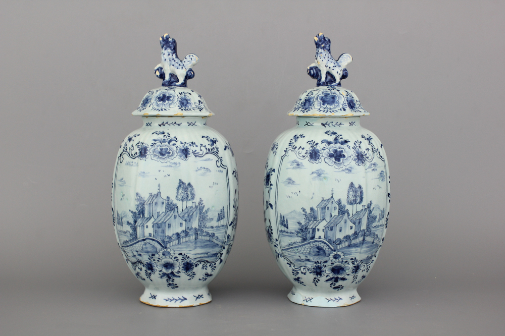 A pair of Dutch Delft blue and white vases and covers, 18th C.
