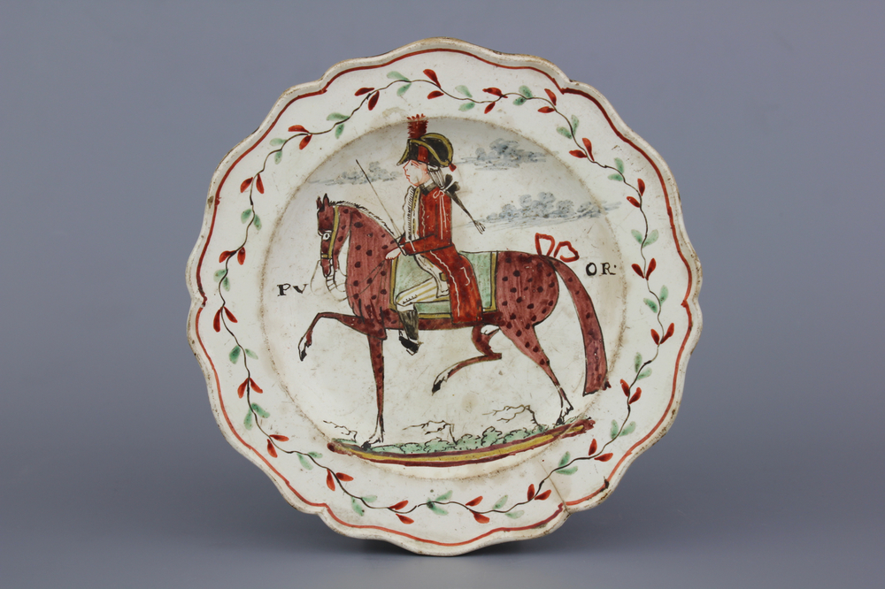 A Dutch-decorated English Leeds orangist creamware plate with a royal equestrian portrait, 18th C.