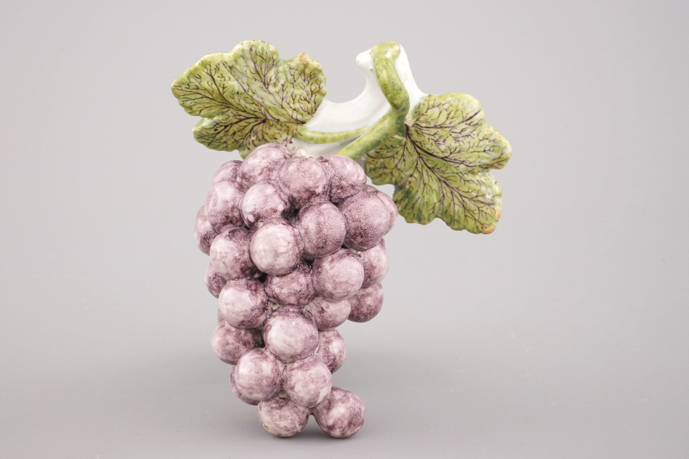 A Dutch Delft polychrome group of grapes, 18th C.