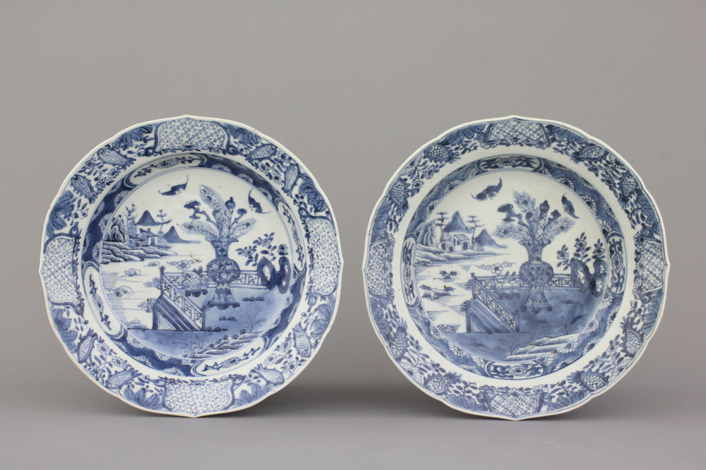 A pair of Chinese porcelain blue and white plates with landscape decoration, 18th C.