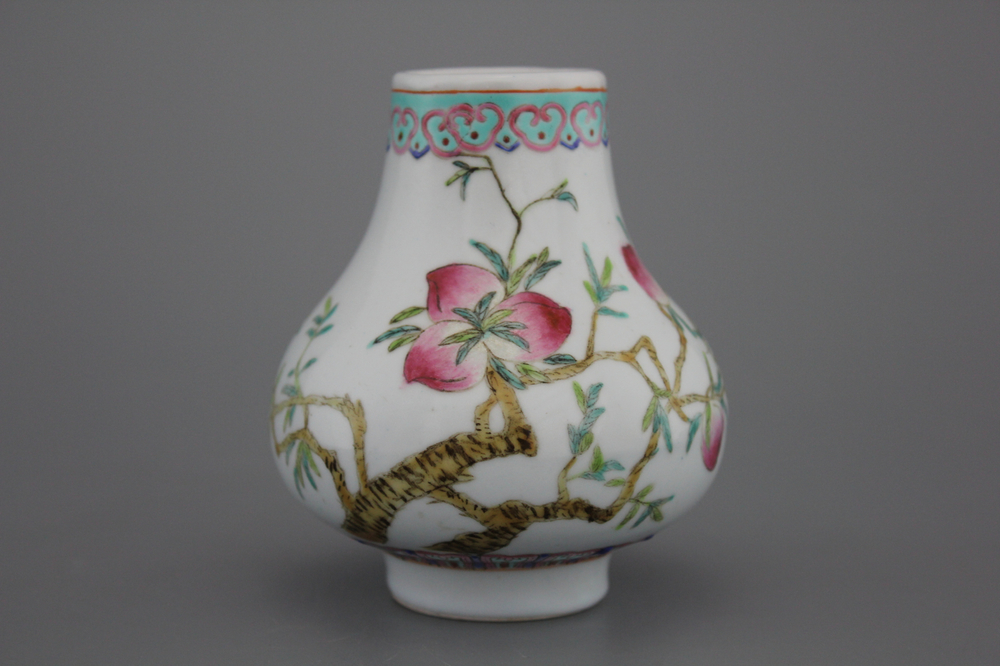 A Chinese porcelain famille rose small nine peaches vase, 19th C.