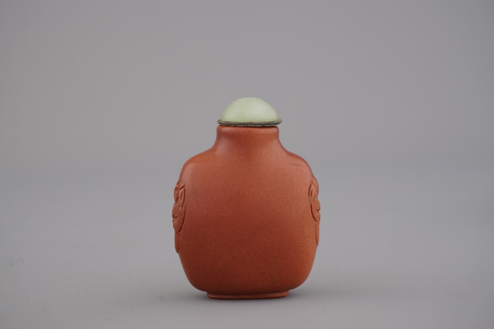 A Chinese polished gold stone snuff bottle with celadon jade lid