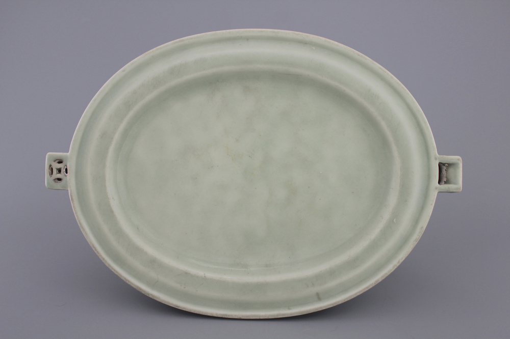 A Chinese porcelain celadon plate warmer, 18/19th C.