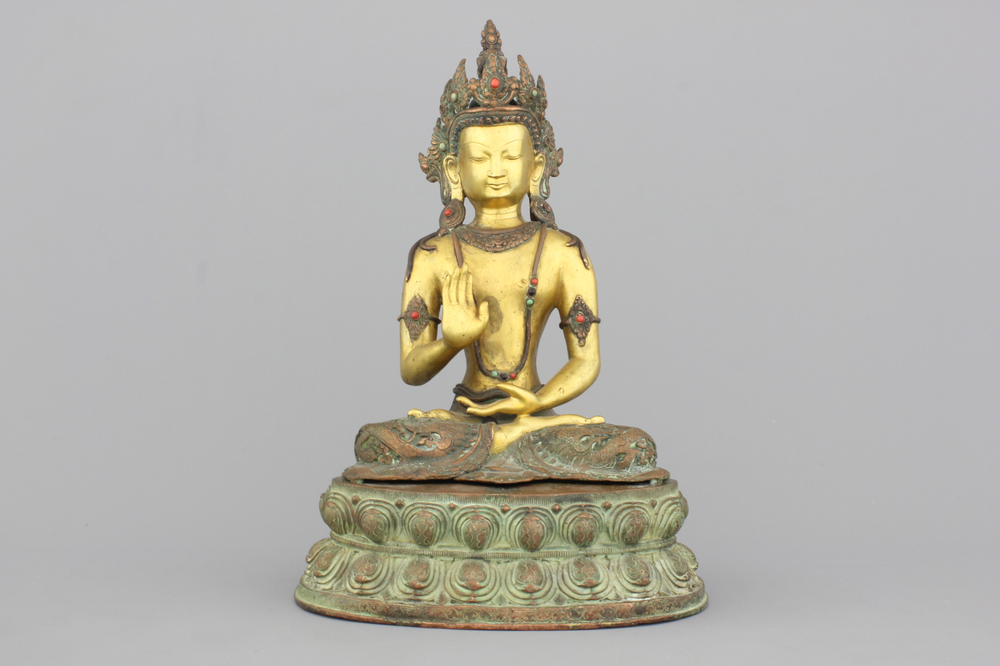 A gilt bronze coral and turquoise inlaid figure of buddha Amoghasiddi, 18/19th C.