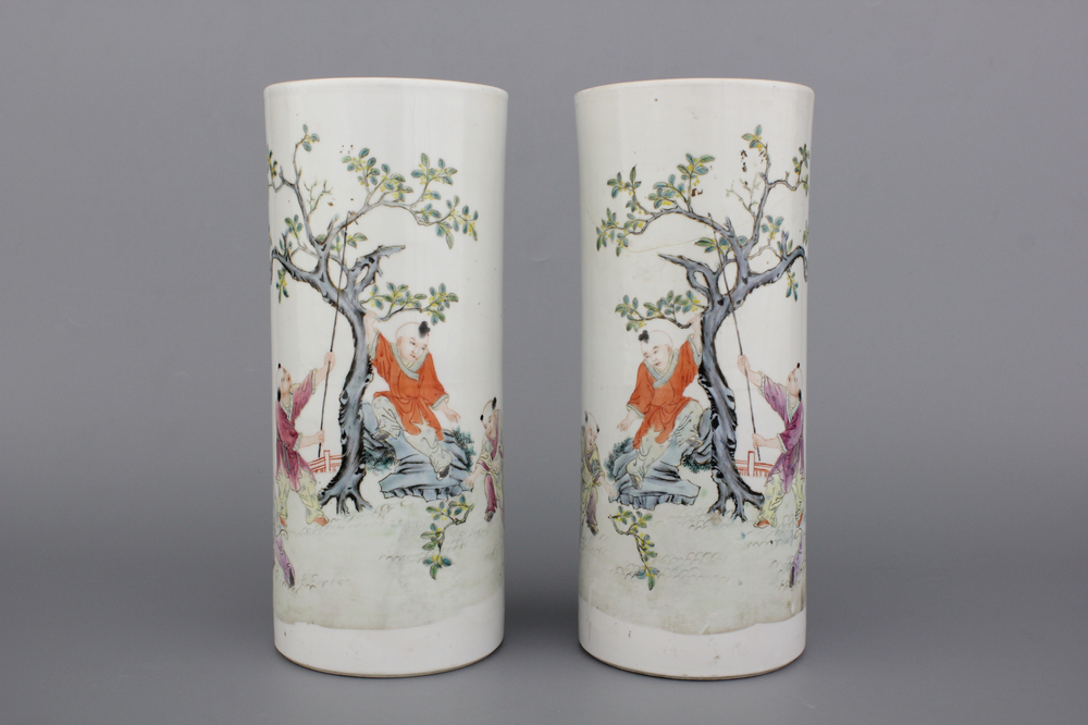 A pair of Chinese porcelain hat stands with playing boys, 19th C.