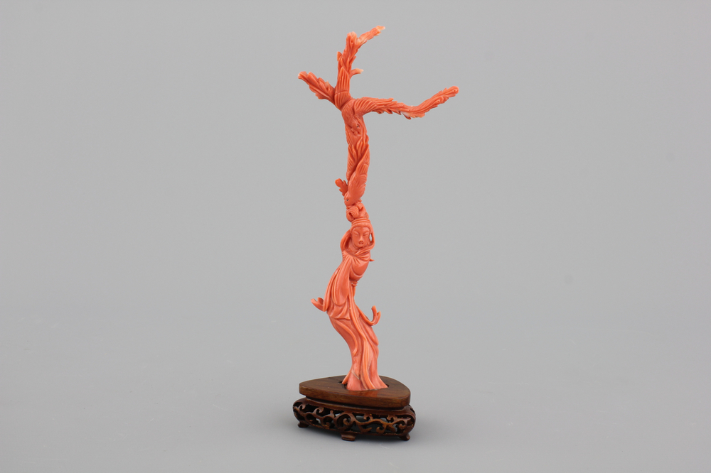 A fine sculpted Chinese red coral branch with a Guanyin, birds and flowers, 19th C.
