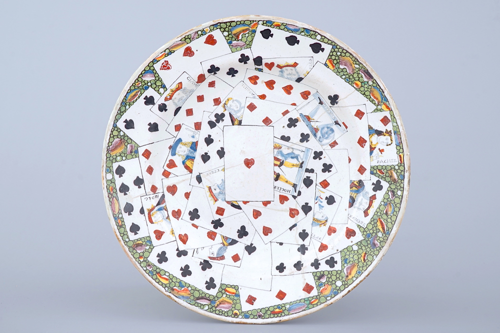 A large French faience dish with playing cards, Lille, 18th C.