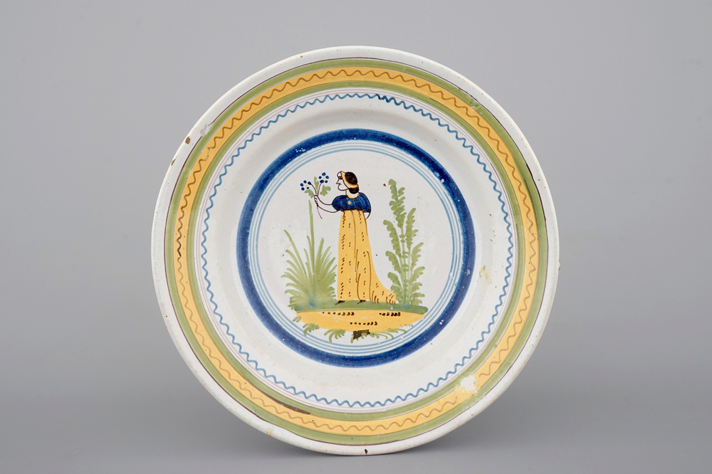 A Brussels faience plate with a lady, 18th C.