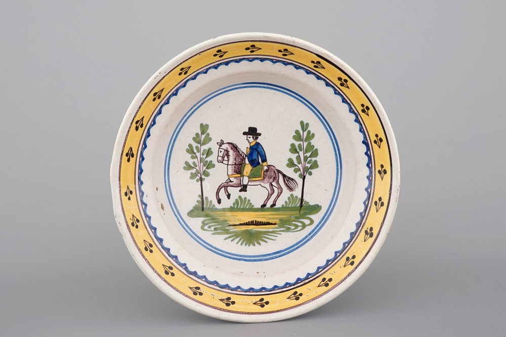 A Brussels faience plate with a knight on horseback, 18th C.