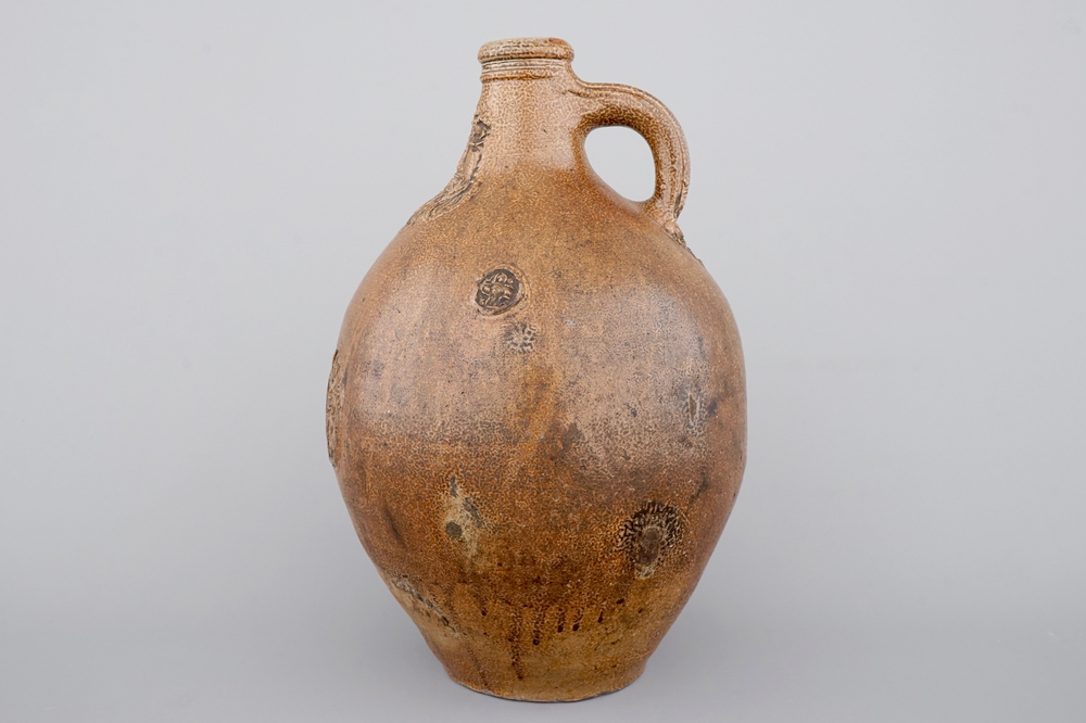 A tall Raeren saltglaze stoneware &quot;Bartmann&quot; or &quot;Beardman&quot; jug, early 17th C.