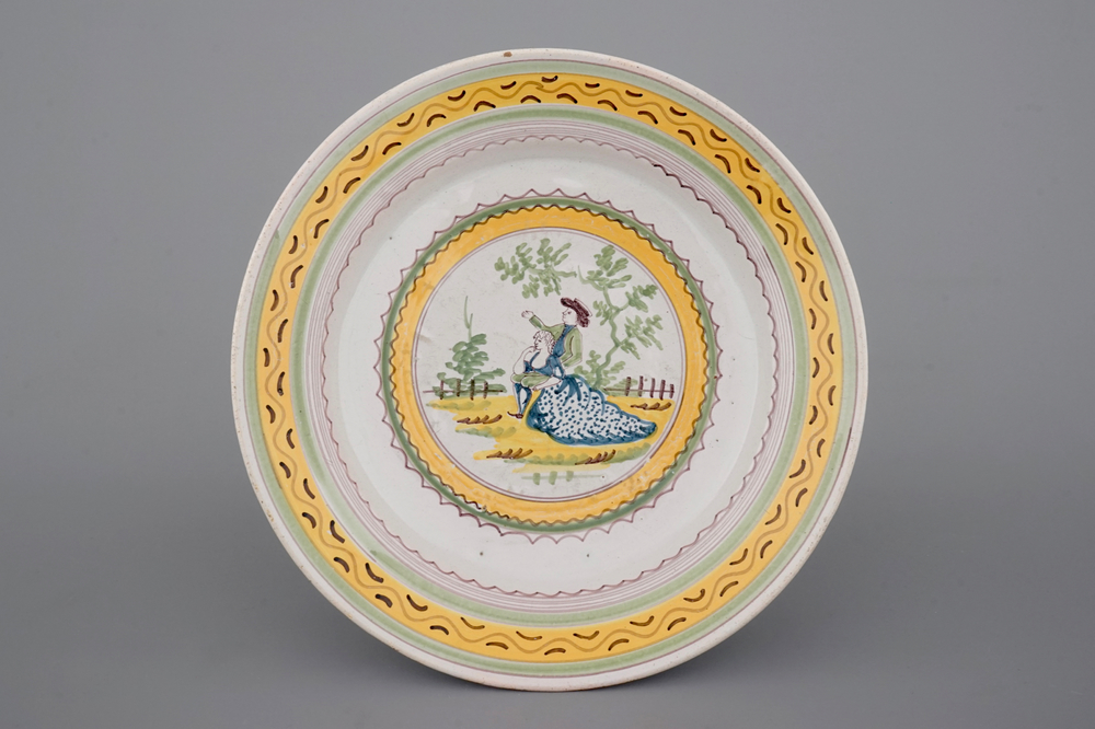 A fine Brussels faience plate with a romantic scene, 18th C.