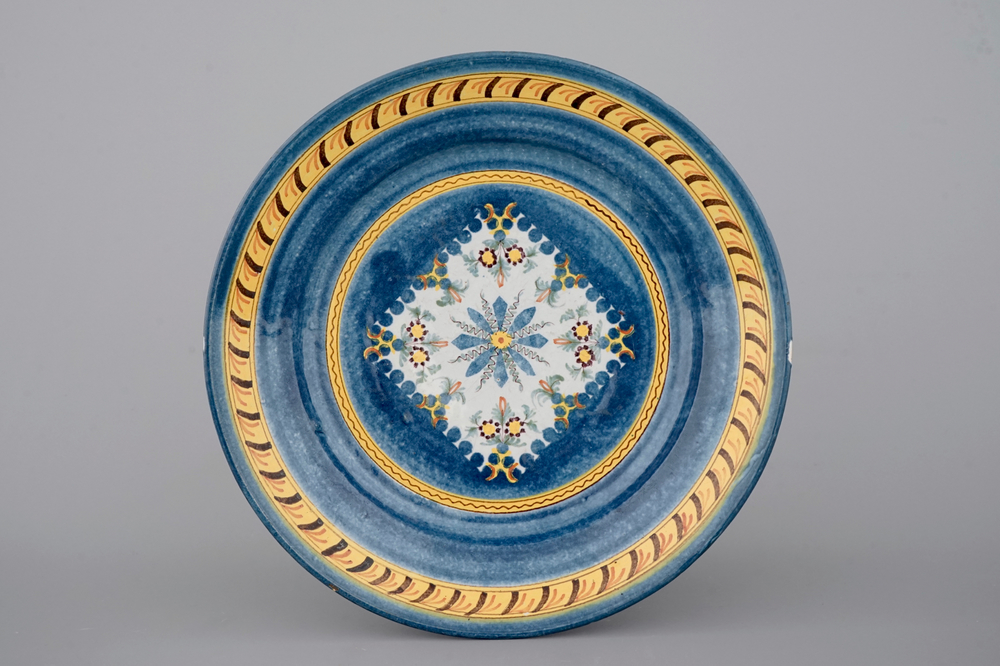 A Brussels faience blue-ground plate with floral decoration, 18th C.