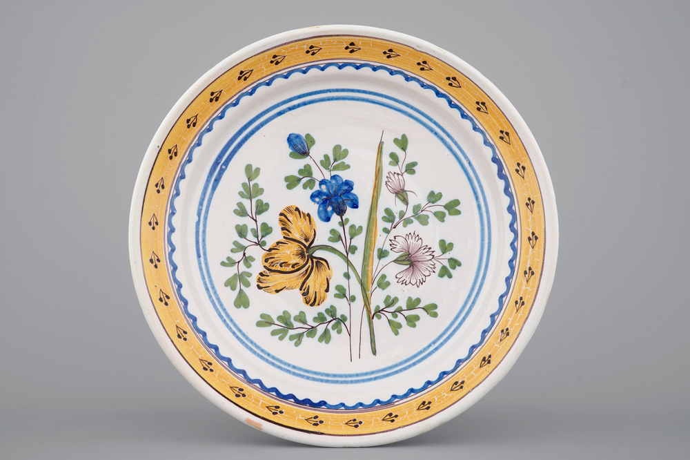 A Brussels faience plate with a bouquet of flowers, 18th C.