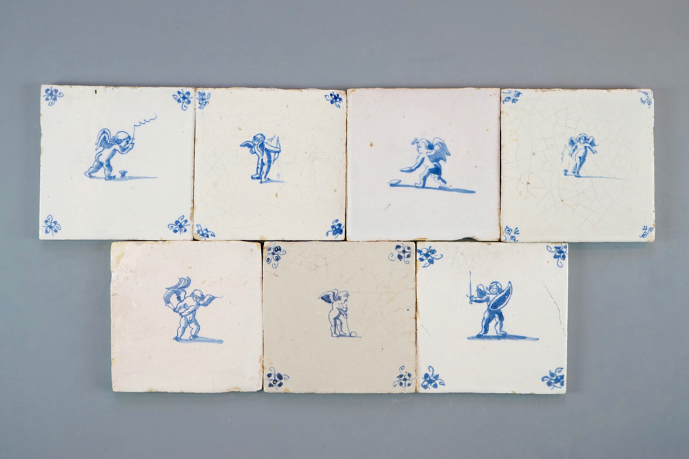 A set of 7 Dutch Delft blue and white tiles with putti or amors, 17/18th C.