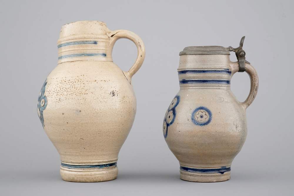 Two globular Westerwald stoneware jugs in blue and incised, one with pewter lid, 17th C.